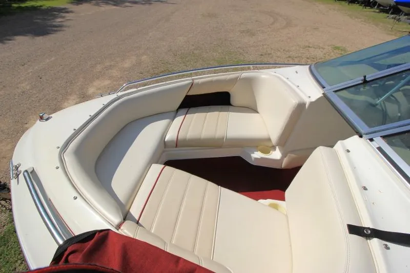 Slide: The Image of 1994 Sea Ray 180 Bow Rider boat with white seating and red accents. - 16