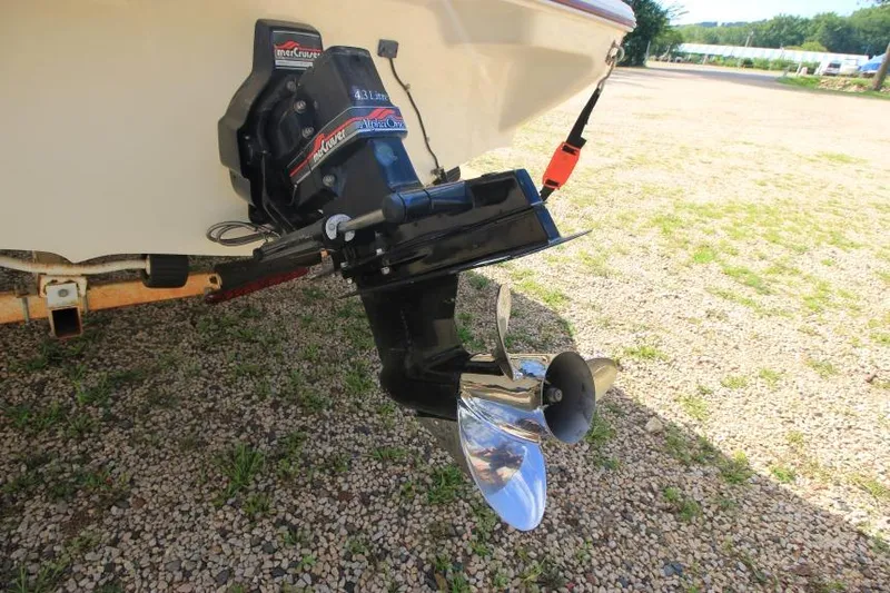 Slide: The Image of 1994 Sea Ray 180 Bow Rider boat with MerCruiser outboard engine on gravel. - 4