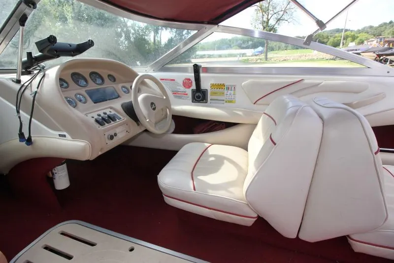Slide: The Image of 1994 Sea Ray 180 Bow Rider interior with white seats and dashboard controls. - 6