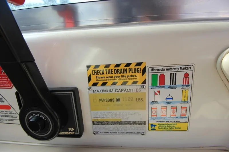 Slide: The Image of 1994 Sea Ray 180 Bow Rider dashboard with safety and capacity labels. - 9