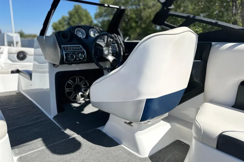 Slide: The Image of 2014 Axis A24 boat interior with steering wheel and white seating. - 10
