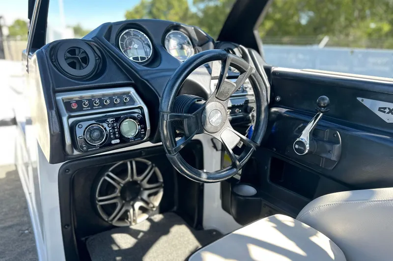 Slide: The Image of 2014 Axis A24 boat dashboard with steering wheel, controls, and audio system. - 11