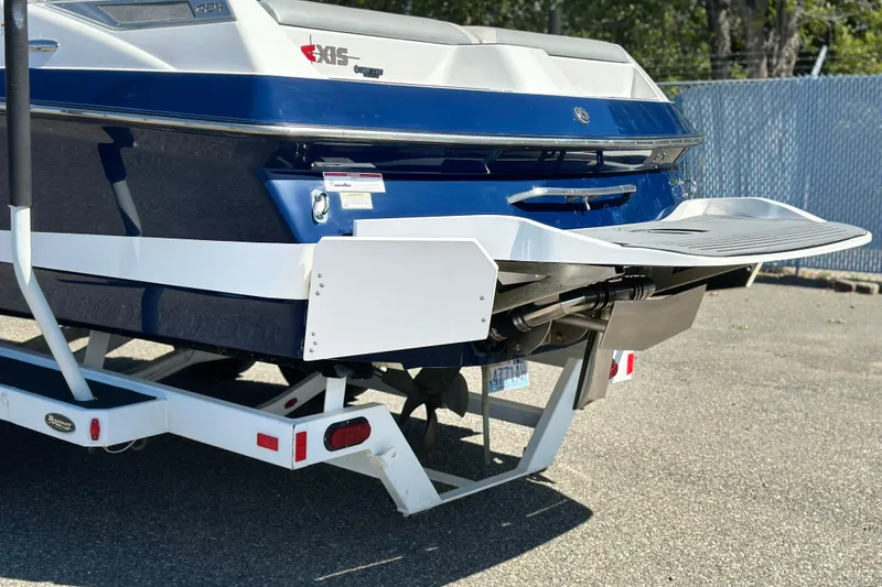 Slide: The Image of 2014 Axis A24 boat rear view with swim platform and trailer. - 3