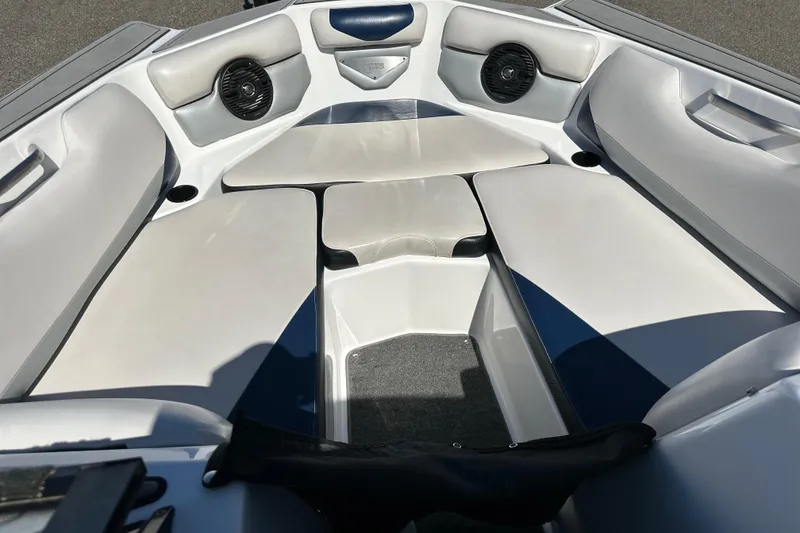 Slide: The Image of Interior of a 2014 Axis A24 boat with cushioned seating and built-in speakers. - 5