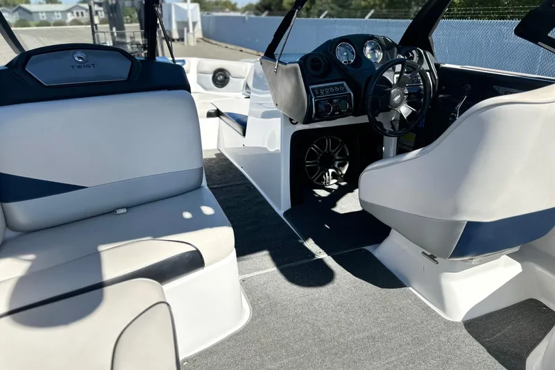 Slide: The Image of 2014 Axis A24 boat interior with steering wheel, seating, and dashboard controls. - 6