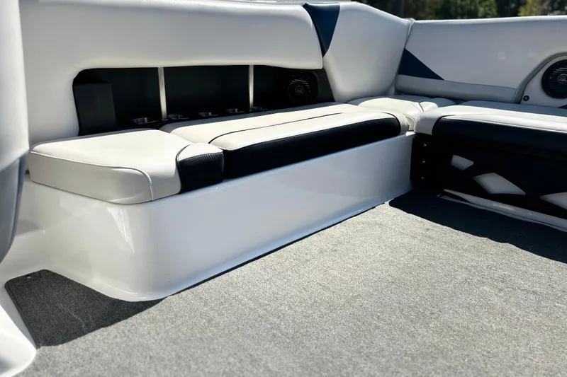 Slide: The Image of 2014 Axis A24 boat interior with white and black seating, carpeted floor. - 9