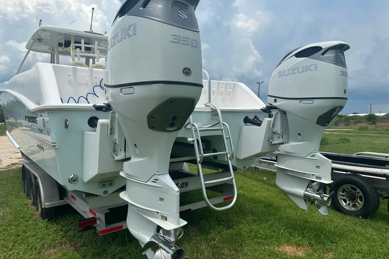 Slide: The Image of 2023 Twin Vee 340 GFX CC boat with dual Suzuki 350 outboard engines on a trailer. - 11