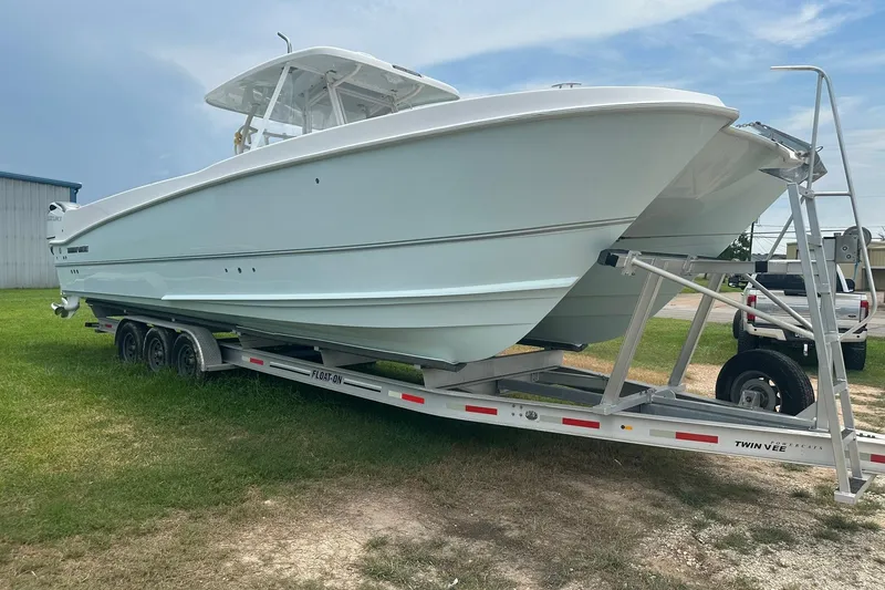 Slide: The Image of 2023 Twin Vee 340 GFX CC boat on trailer, parked on grass. - 14