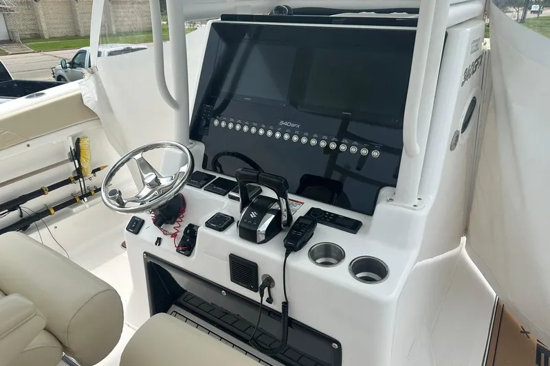 Slide: The Image of 2023 Twin Vee 340 GFX CC boat console with steering wheel and controls. - 18