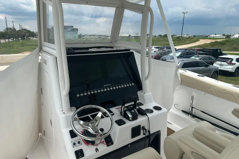 Slide: The Image of 2023 Twin Vee 340 GFX CC boat cockpit with modern steering and controls. - 19