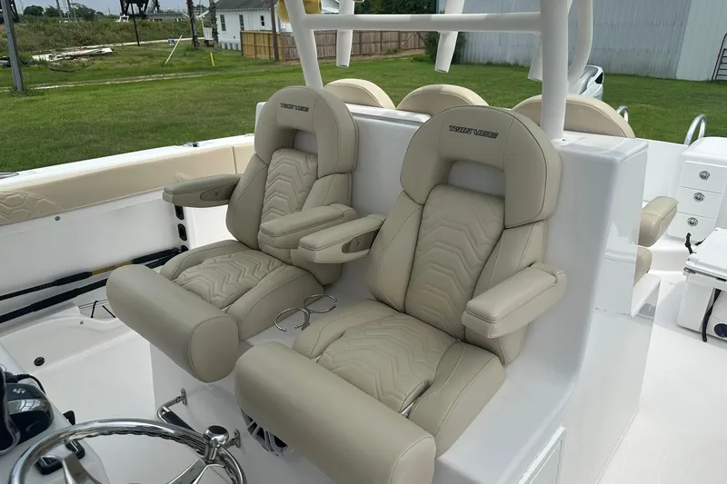 Slide: The Image of 2023 Twin Vee 340 GFX CC boat with luxurious beige seating and modern design. - 22