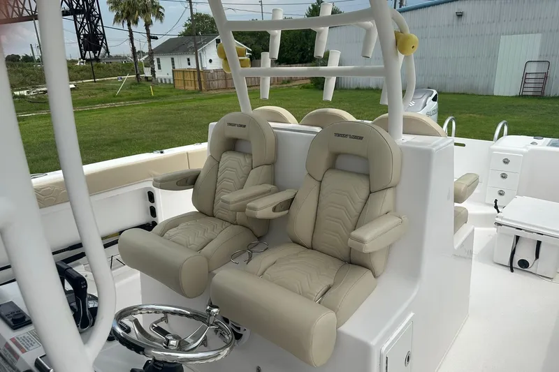 Slide: The Image of 2023 Twin Vee 340 GFX CC boat with luxurious beige seating and modern helm. - 24