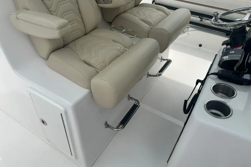 Slide: The Image of 2023 Twin Vee 340 GFX CC boat interior with beige leather seats and steering console. - 25