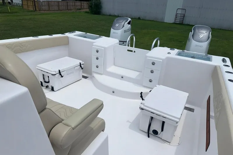 Slide: The Image of 2023 Twin Vee 340 GFX CC boat interior with seating, storage, and dual Suzuki engines. - 27