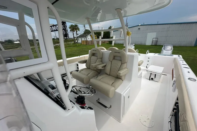 Slide: The Image of 2023 Twin Vee 340 GFX CC boat interior with dual captain seats and steering console. - 31