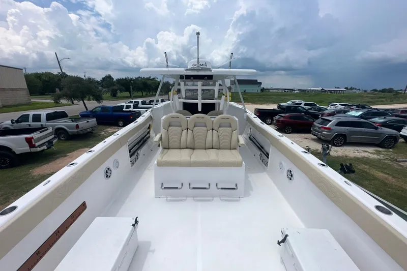 Slide: The Image of 2023 Twin Vee 340 GFX CC boat with spacious deck and seating, parked outdoors. - 34