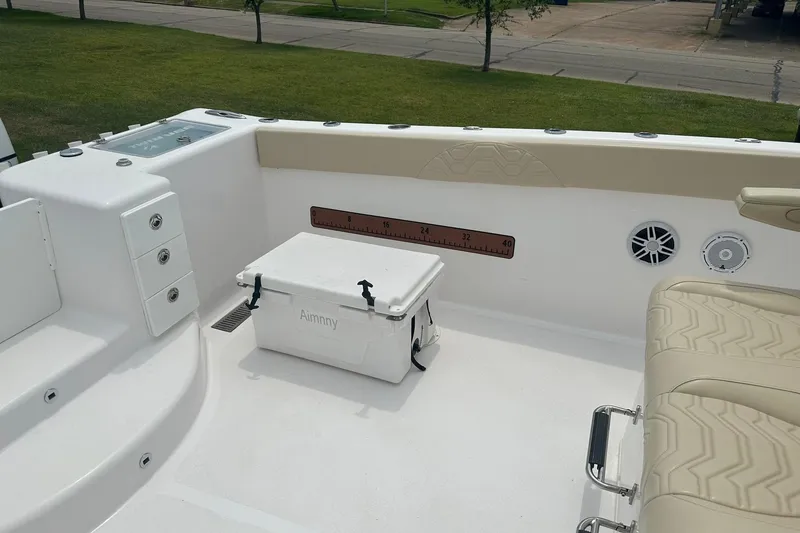 Slide: The Image of 2023 Twin Vee 340 GFX CC boat interior with seating, cooler, and storage compartments. - 36