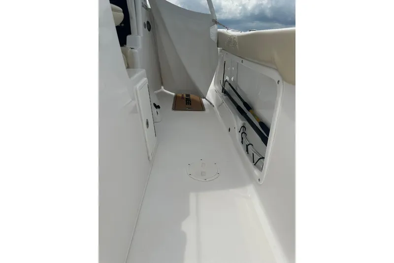 Slide: The Image of 2023 Twin Vee 340 GFX CC boat interior with storage compartments and seating. - 42