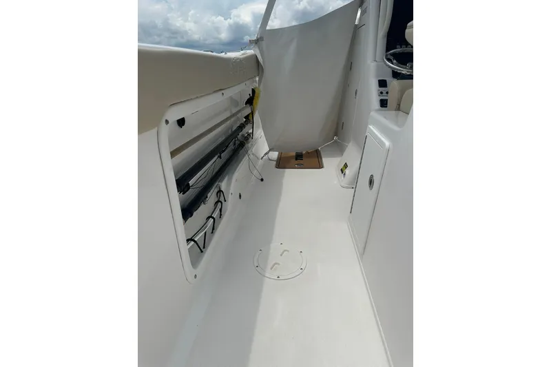Slide: The Image of 2023 Twin Vee 340 GFX CC boat interior with rod storage and helm area. - 43