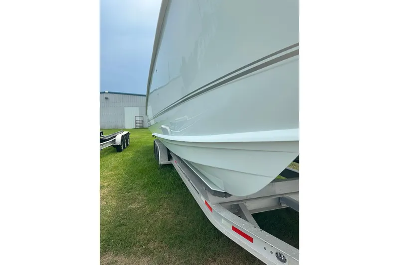 Slide: The Image of 2023 Twin Vee 340 GFX CC boat on trailer, side view, outdoors. - 5