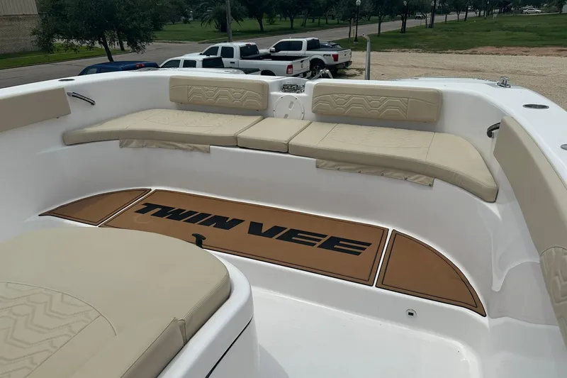 Slide: The Image of 2023 Twin Vee 340 GFX CC boat interior with beige seating and logo mat. - 50