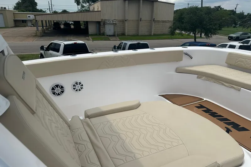 Slide: The Image of 2023 Twin Vee 340 GFX CC boat interior with beige seating and speakers. - 51