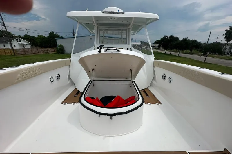 Slide: The Image of 2023 Twin Vee 340 GFX CC boat with open storage compartment and life jackets. - 55