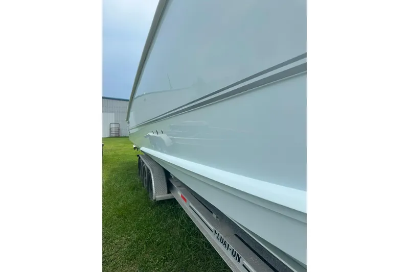 Slide: The Image of 2023 Twin Vee 340 GFX CC boat on trailer, side view, outdoors. - 6