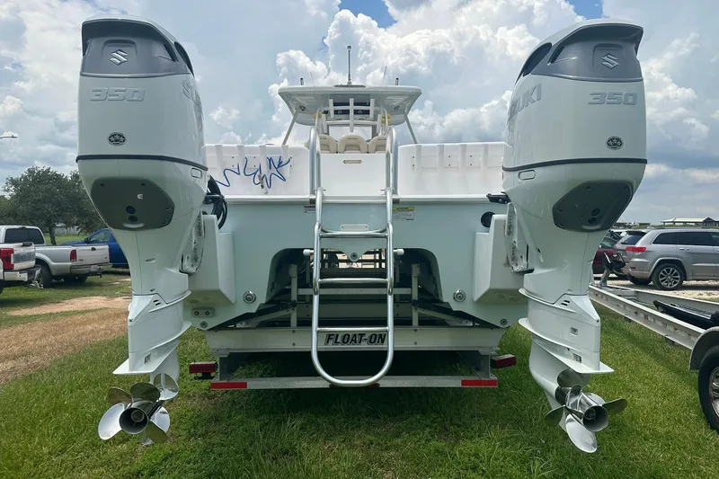 Slide: The Image of 2023 Twin Vee 340 GFX CC boat with dual Suzuki 350 engines on a trailer. - 8