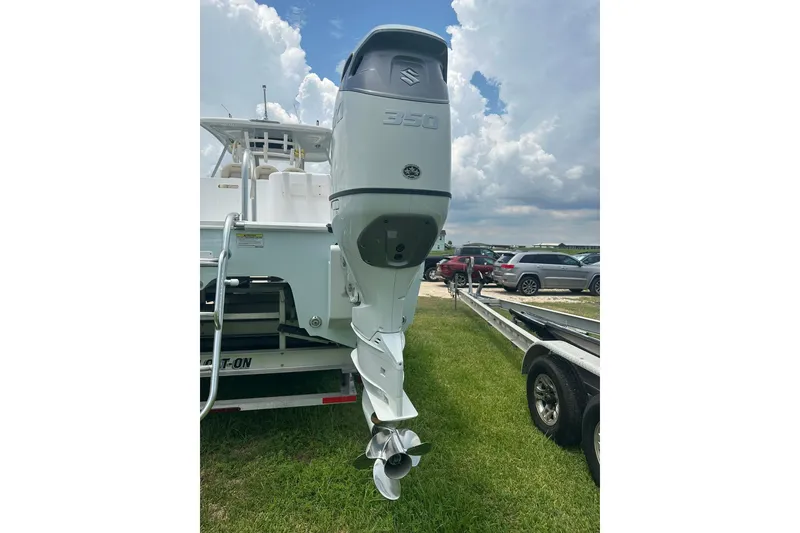 Slide: The Image of 2023 Twin Vee 340 GFX CC boat with Suzuki 350 outboard motor on trailer. - 9