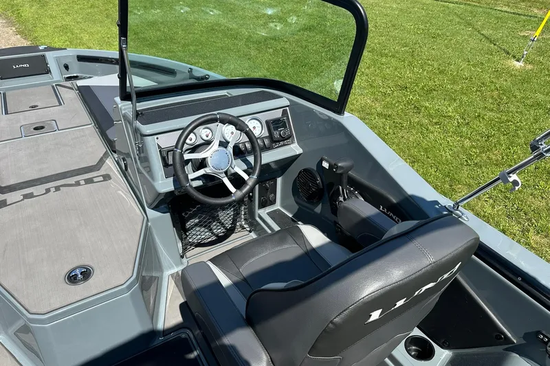 Slide: The Image of 2026 Lund 185 Impact GL boat interior with steering wheel and dashboard. - 16