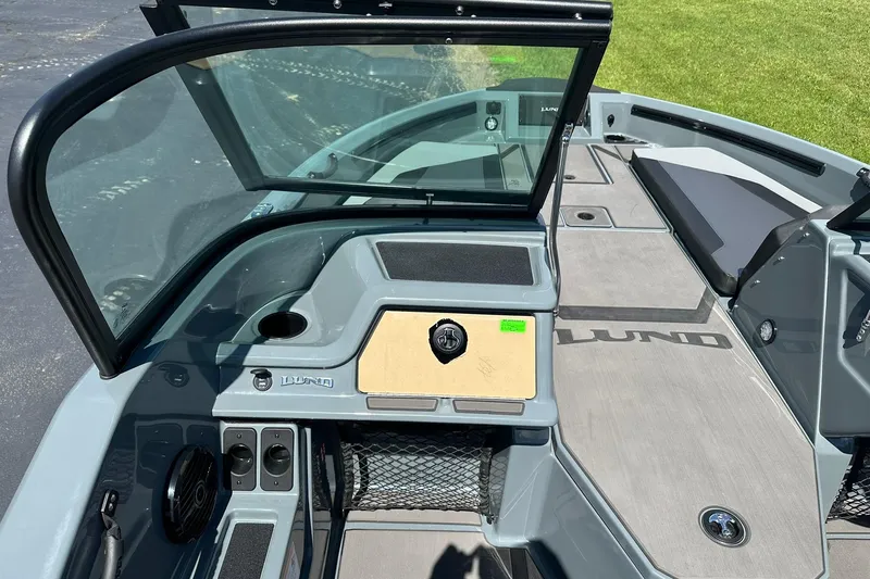 Slide: The Image of 2026 Lund 185 Impact GL boat interior with windshield and dashboard view. - 19