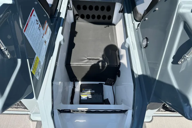 Slide: The Image of Interior storage compartment of 2026 Lund 185 Impact GL boat with Minn Kota Precision charger. - 21