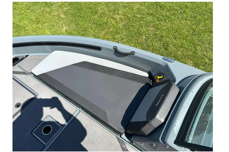 Slide: The Image of 2026 Lund 185 Impact GL boat interior with cushioned seating and storage compartment. - 26