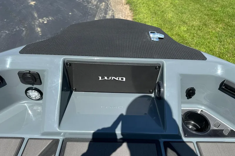 Slide: The Image of 2026 Lund 185 Impact GL boat dashboard with cup holder and control panel. - 29