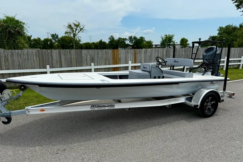 The Image of 2026 Maverick 17 HPX-S boat on trailer, parked outdoors near wooden fence. - 1