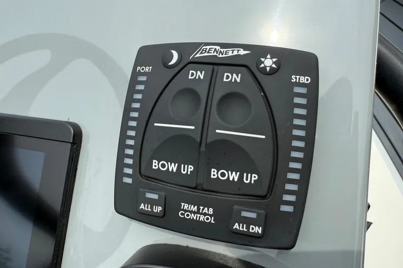 Slide: The Image of Bennett trim tab control panel on 2026 Maverick 17 HPX-S boat dashboard. - 16