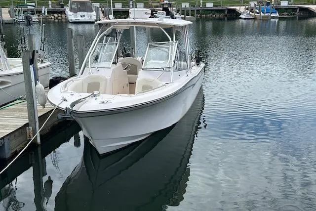 Slide: The Image of 2010 Grady-White Tournament 275 boat with twin Yamaha engines docked at marina. - 1