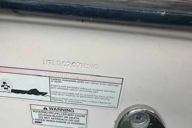 Slide: The Image of 2010 Grady-White Tournament 275 boat interior seating detail with beige and white upholstery. - 3