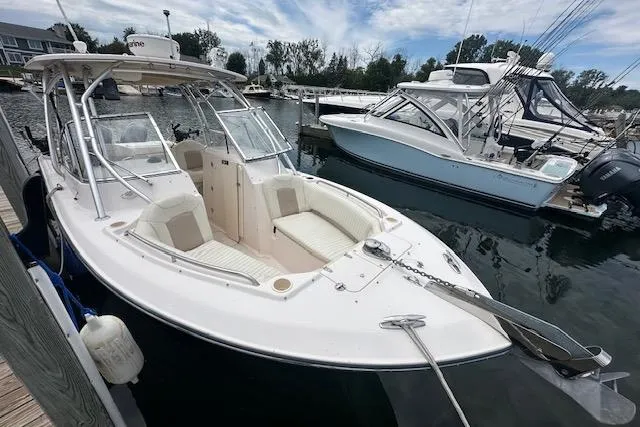 Slide: The Image of 2010 Grady-White Tournament 275 boat docked at marina, featuring spacious seating and sleek design. - 5