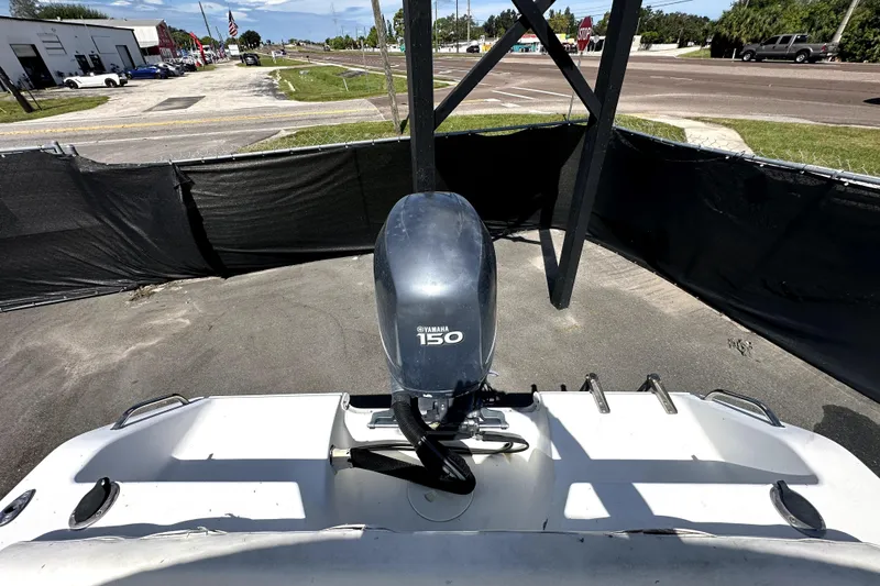 Slide: The Image of 2008 Sea Hunt Ultra 196 boat with Yamaha 150 outboard motor in a parking area. - 40