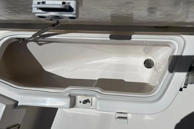 Slide: The Image of 2023 Robalo R200 Center Console boat storage compartment, open and empty. - 15