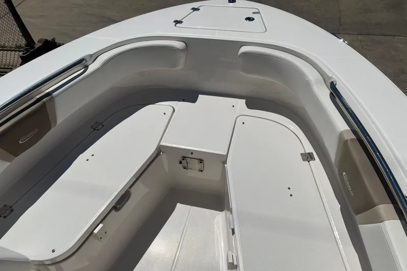 Slide: The Image of 2023 Robalo R200 Center Console boat interior with white seating and storage compartments. - 17