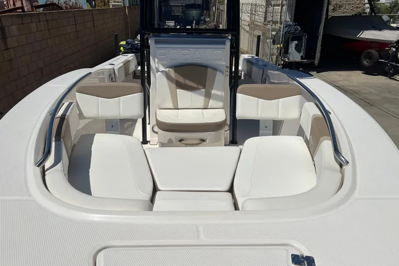Slide: The Image of 2023 Robalo R200 Center Console boat interior with white seating and stainless steel railings. - 24