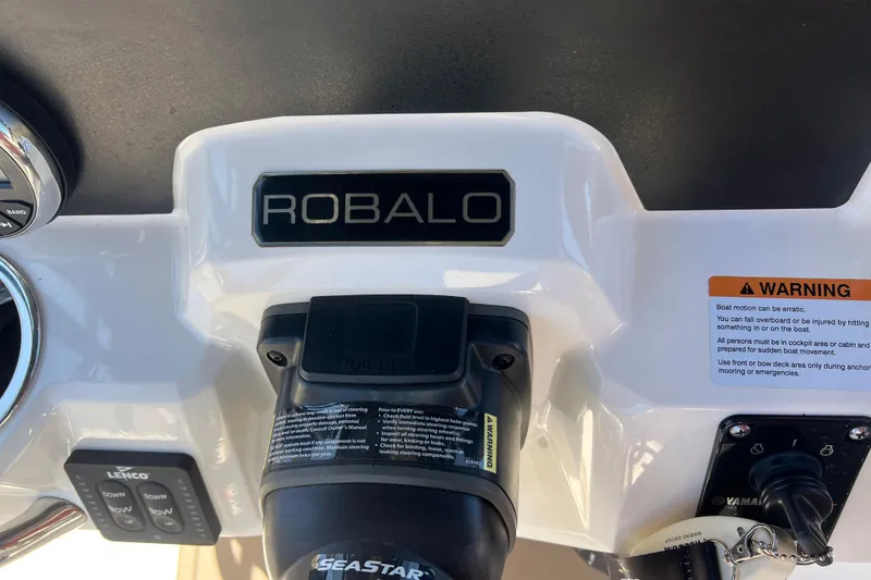 Slide: The Image of 2023 Robalo R200 Center Console dashboard with controls and warning label. - 26