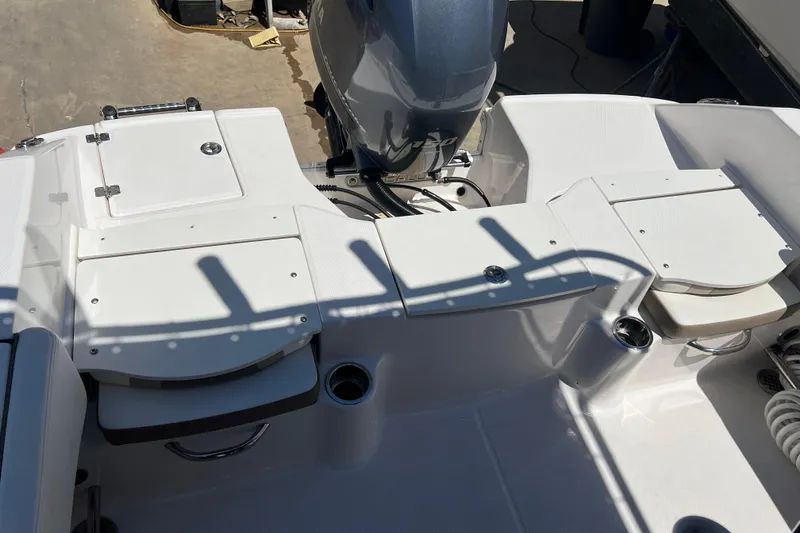 Slide: The Image of 2023 Robalo R200 Center Console boat interior with seating and engine view. - 30