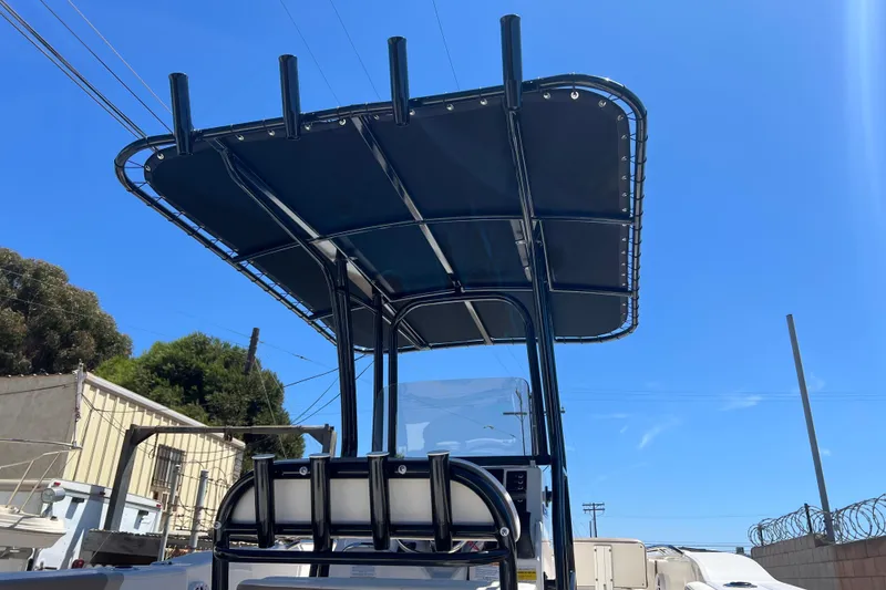 Slide: The Image of 2023 Robalo R200 Center Console boat with T-top under clear blue sky. - 35