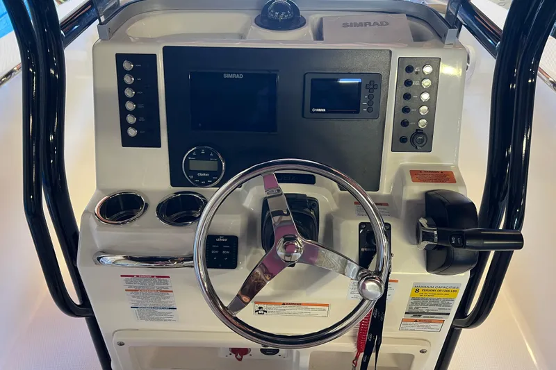 Slide: The Image of 2023 Robalo R200 Center Console boat dashboard with steering wheel and controls. - 38