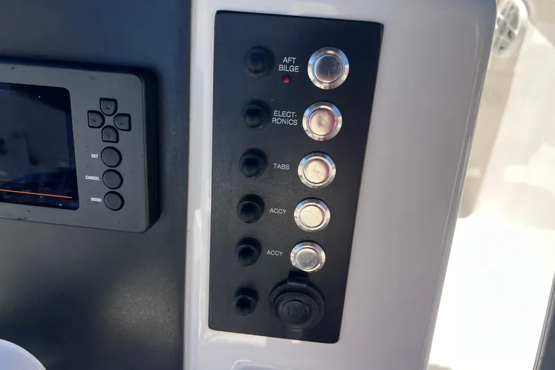 Slide: The Image of 2023 Robalo R200 Center Console dashboard with control panel and electronic switches. - 41