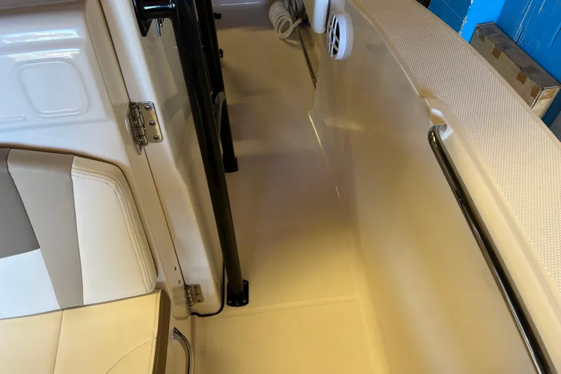 Slide: The Image of 2023 Robalo R200 Center Console interior with beige seating and stainless steel fixtures. - 43
